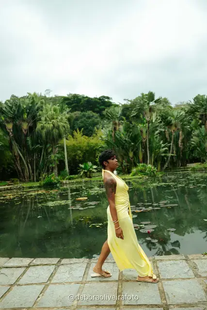 Woman in a yellow dress by the lily pond in the Rio de Janeiro Botanical Garden