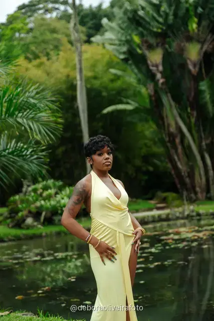 Woman in a yellow dress by the lily pond in the Rio de Janeiro Botanical Garden