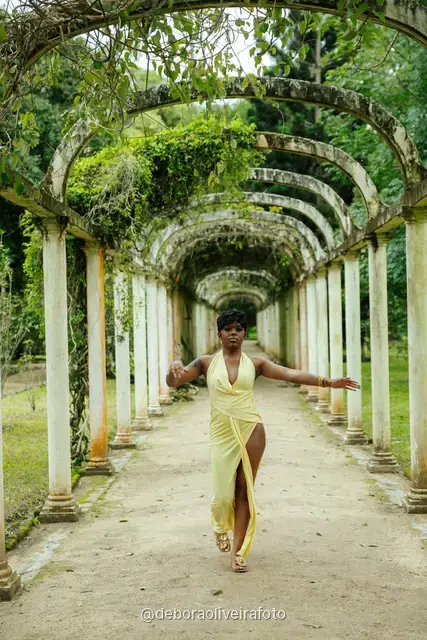 Woman in a yellow dress walking through the arched pergola at the Rio de Janeiro Botanical Garden