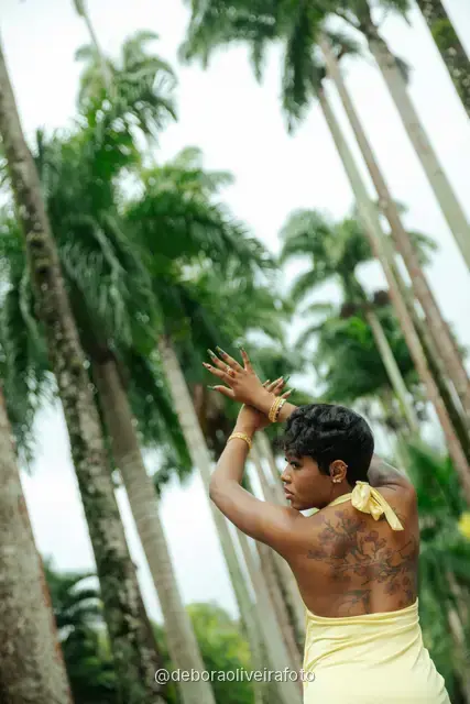 Woman in a yellow dress near the fountain and royal palms at the Rio de Janeiro Botanical Garden