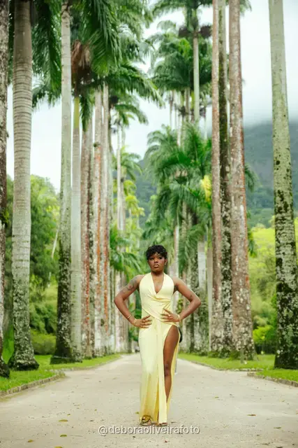 Woman in a yellow dress near the fountain and royal palms at the Rio de Janeiro Botanical Garden