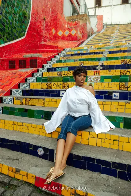 Woman in a white blouse and jeans at the Selarón Steps in Rio de Janeiro