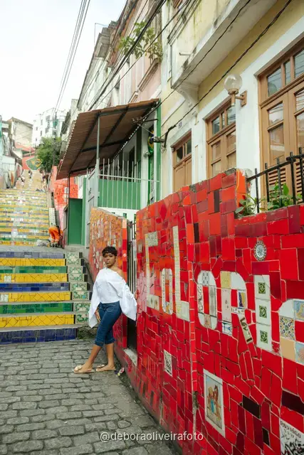 Woman in a white blouse and jeans at the Selarón Steps in Rio de Janeiro