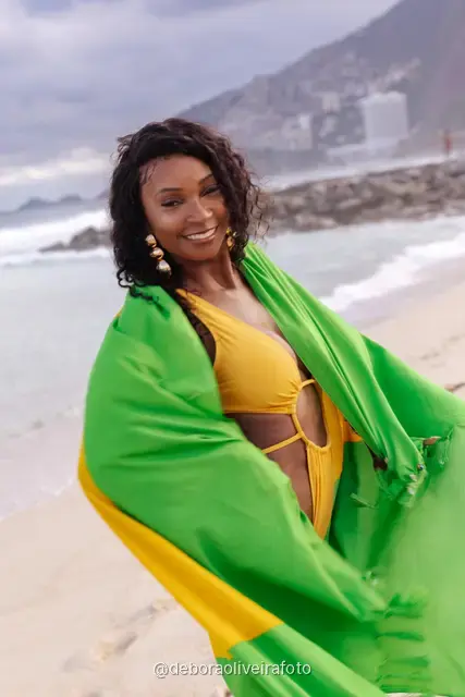 Woman holding the Brazilian flag on Ipanema Beach, Rio de Janeiro