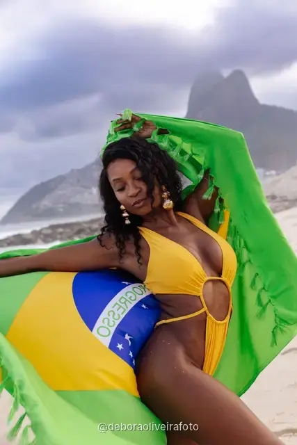 Woman holding the Brazilian flag on Ipanema Beach, Rio de Janeiro