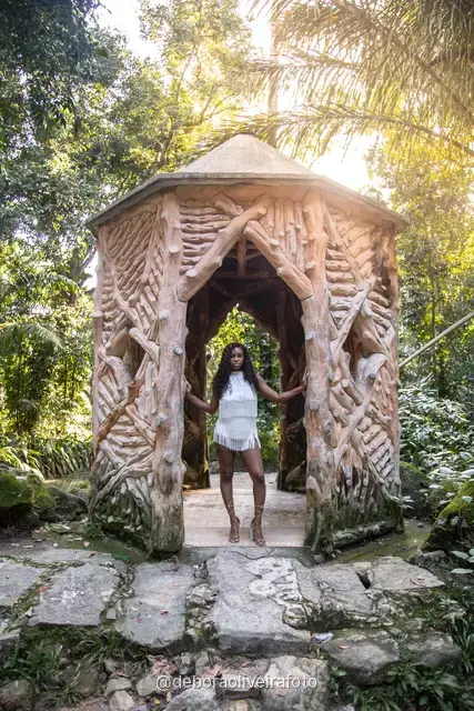 Two women in white at the carved stone gazebo in Parque Lage, Rio de Janeiro