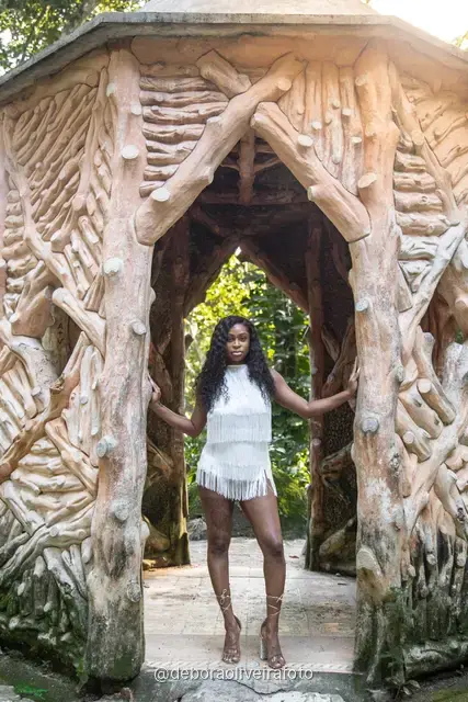 Two women in white at the carved stone gazebo in Parque Lage, Rio de Janeiro