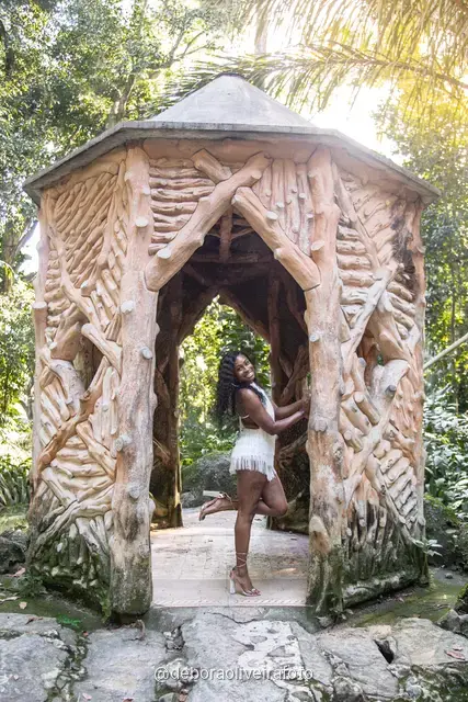 Two women in white at the carved stone gazebo in Parque Lage, Rio de Janeiro
