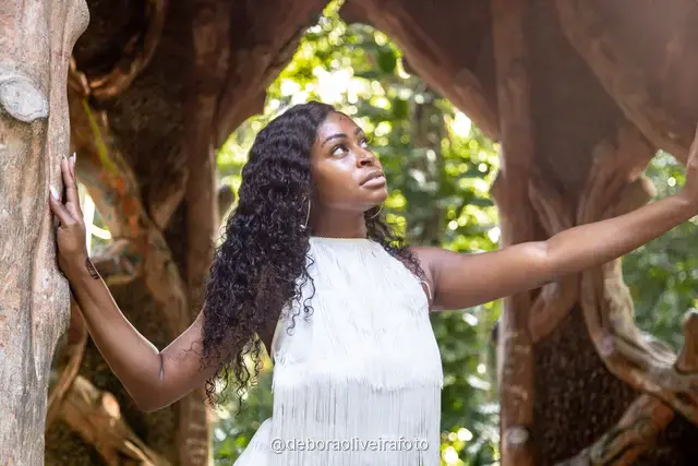 Two women in white at the carved stone gazebo in Parque Lage, Rio de Janeiro