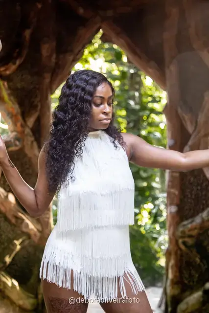 Two women in white at the carved stone gazebo in Parque Lage, Rio de Janeiro