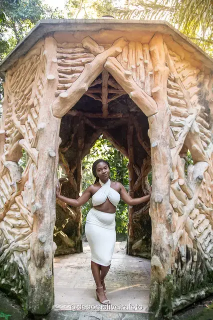 Two women in white at the carved stone gazebo in Parque Lage, Rio de Janeiro