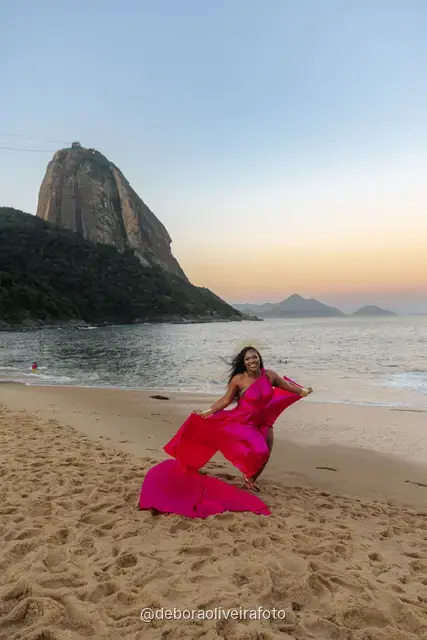 Pink flying dress caught in the wind on the sand at Praia Vermelha, Rio de Janeiro