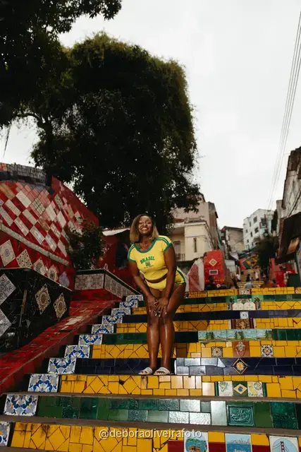 Woman in a yellow Brazil outfit at the Selarón Steps in Santa Teresa, Rio de Janeiro