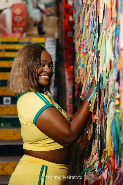 Woman in a yellow Brazil outfit at the Selarón Steps in Santa Teresa, Rio de Janeiro