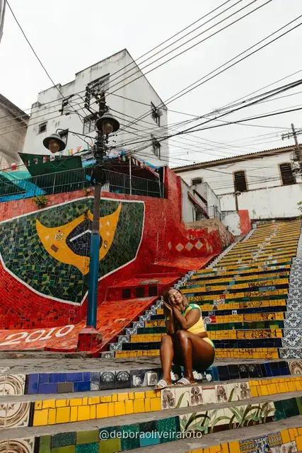 Woman in a yellow Brazil outfit at the Selarón Steps in Santa Teresa, Rio de Janeiro